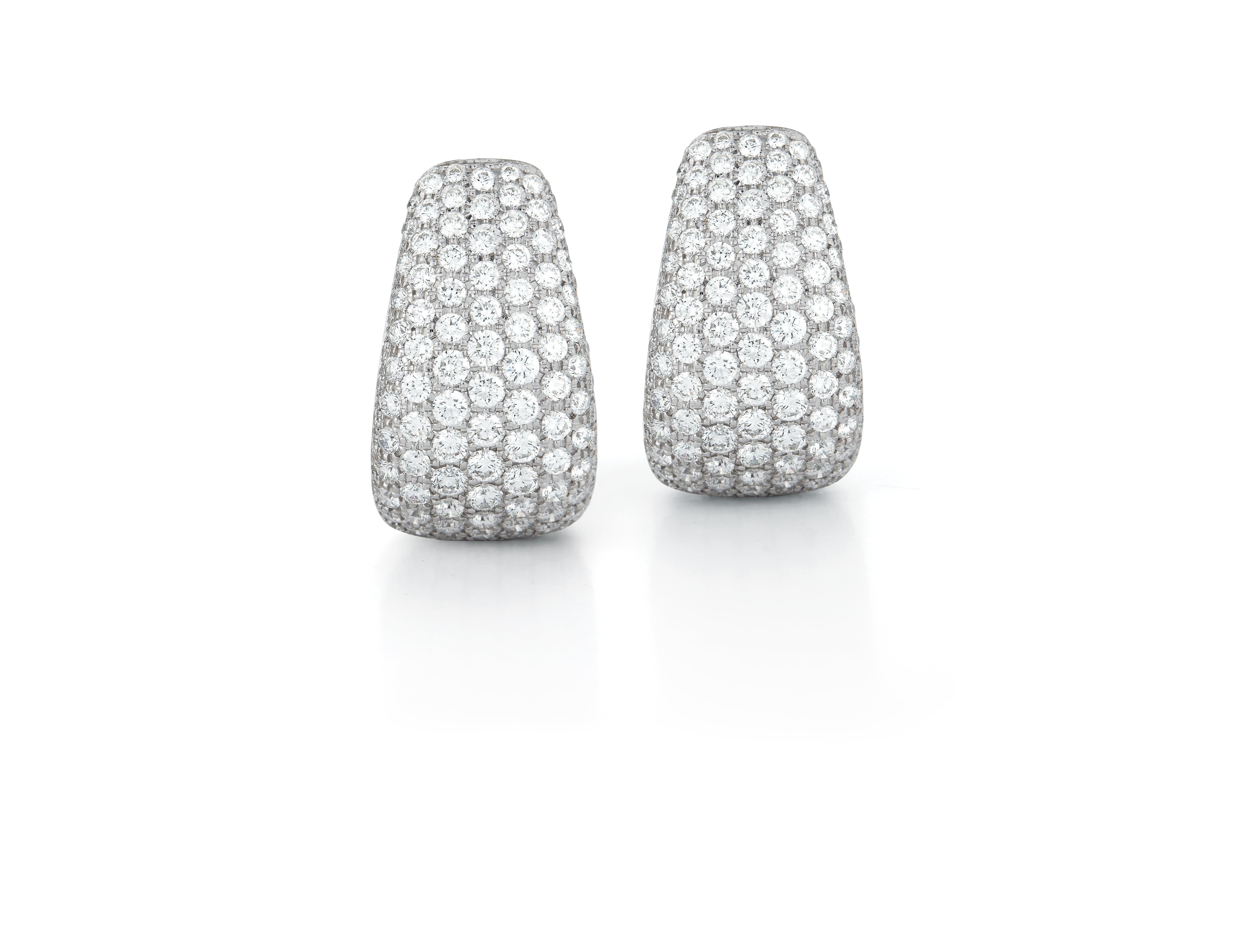 A pair of Buckle Earrings in Diamonds set in 18K White Gold. Signed Seaman Schepps.